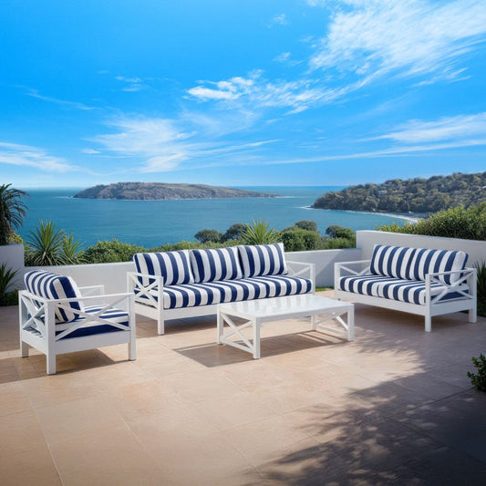Stylish outdoor furniture set with blue-and-white striped cushions overlooking the bay, available at Bay Gallery Furniture.